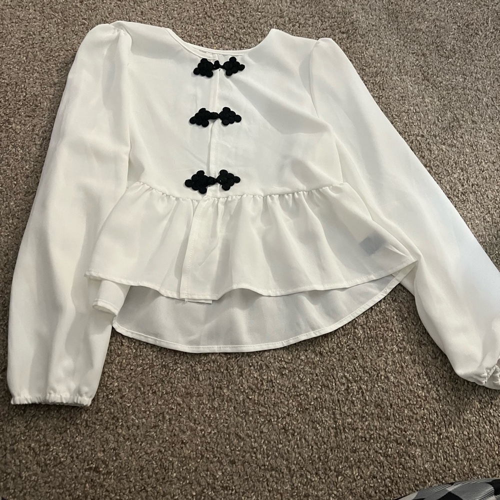 Elegant White Peplum Top with Black Accents